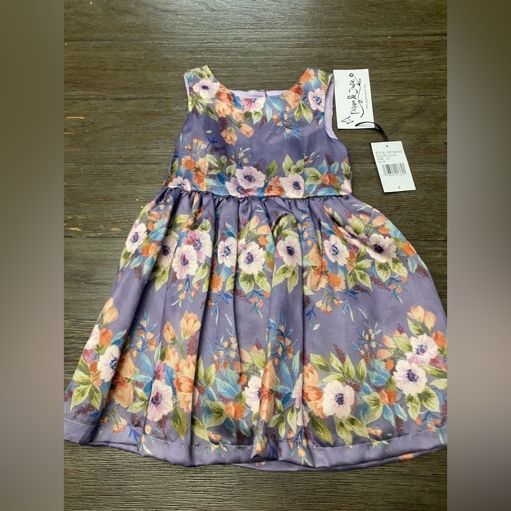 Pippa & Julie brand girl's dress, size 2T, with a lilac floral print.